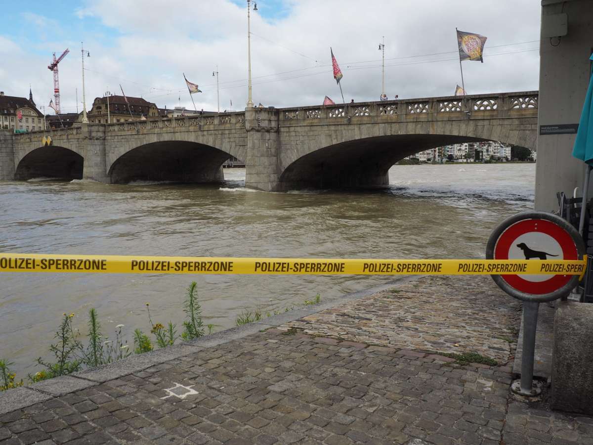 Der Rhein in Basel tost mit mächtig Druck und hohem Pegelstand unter der Mittleren Rheinbrücke hindurch.