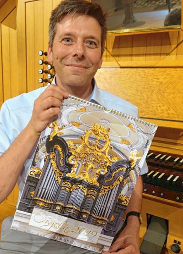 Stolz präsentiert Christoph Bogon den Orgelkalender „Die schönsten Orgeln 2019“,  in dem auch Schopfheim vertreten ist. Foto: Jürgen Scharf